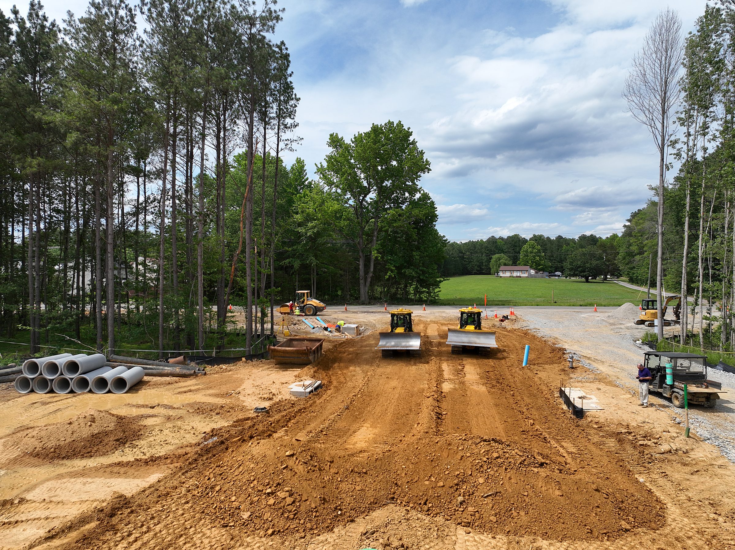 Dozers and site crews spreading fill on a new subdivision road