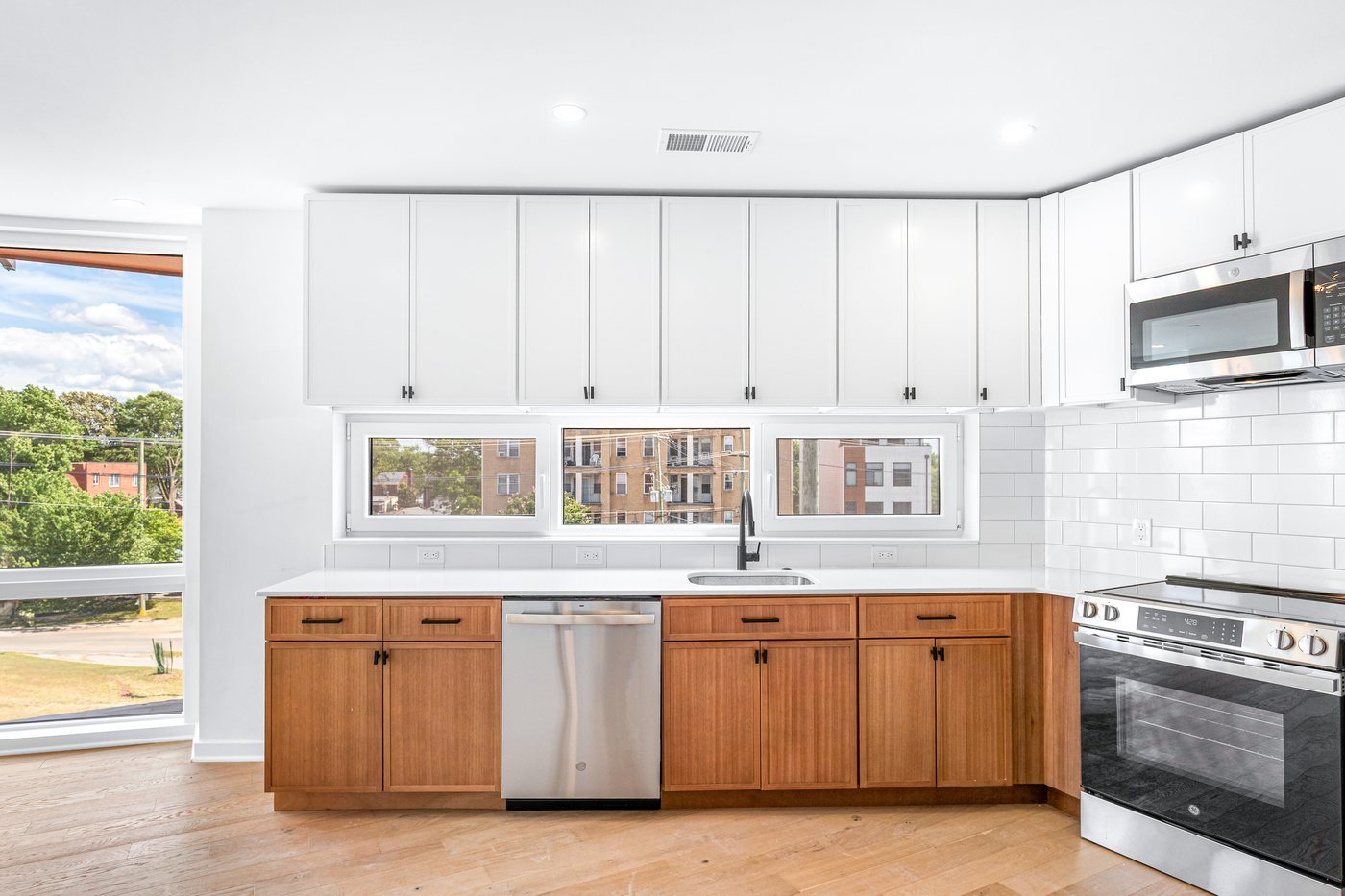 The Bowen, Washington: a kitchen with wood cabinetry and city-facing windows