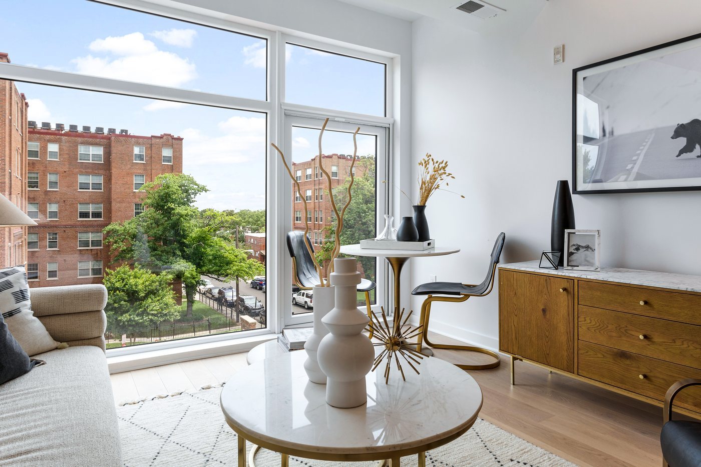 The Seven, Washington: a living room with floor-to-ceiling windows over the street